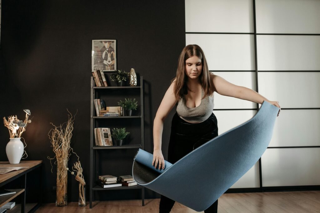Woman using a yoga mat at home to practice a yoga routine for stress relief 