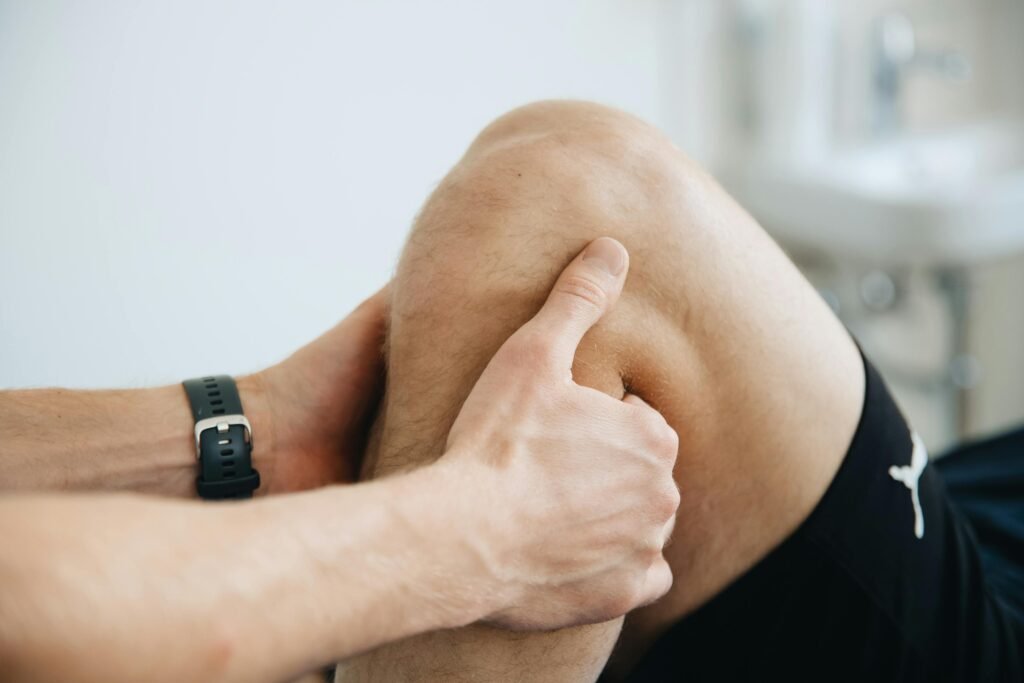 Man being assisted by a partner in doing a yoga routine for knee pain relief